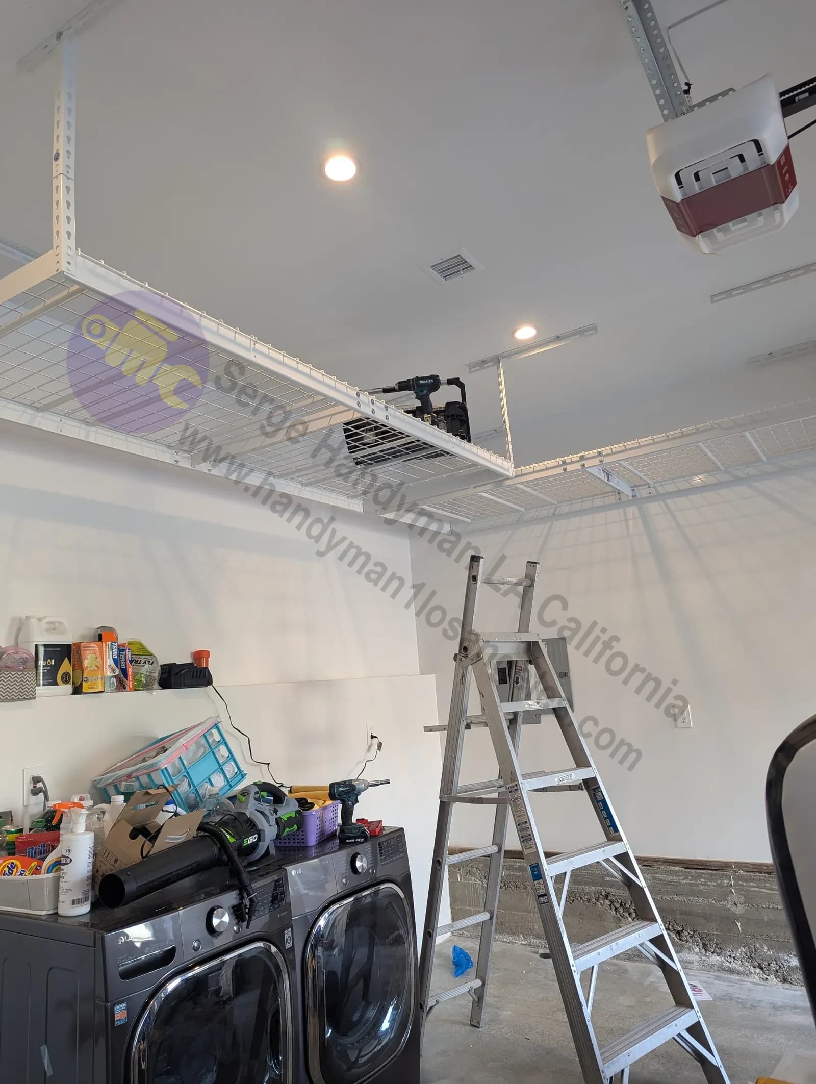 Professional installation of overhead garage storage racks mounted to ceiling joists in Los Angeles garage.