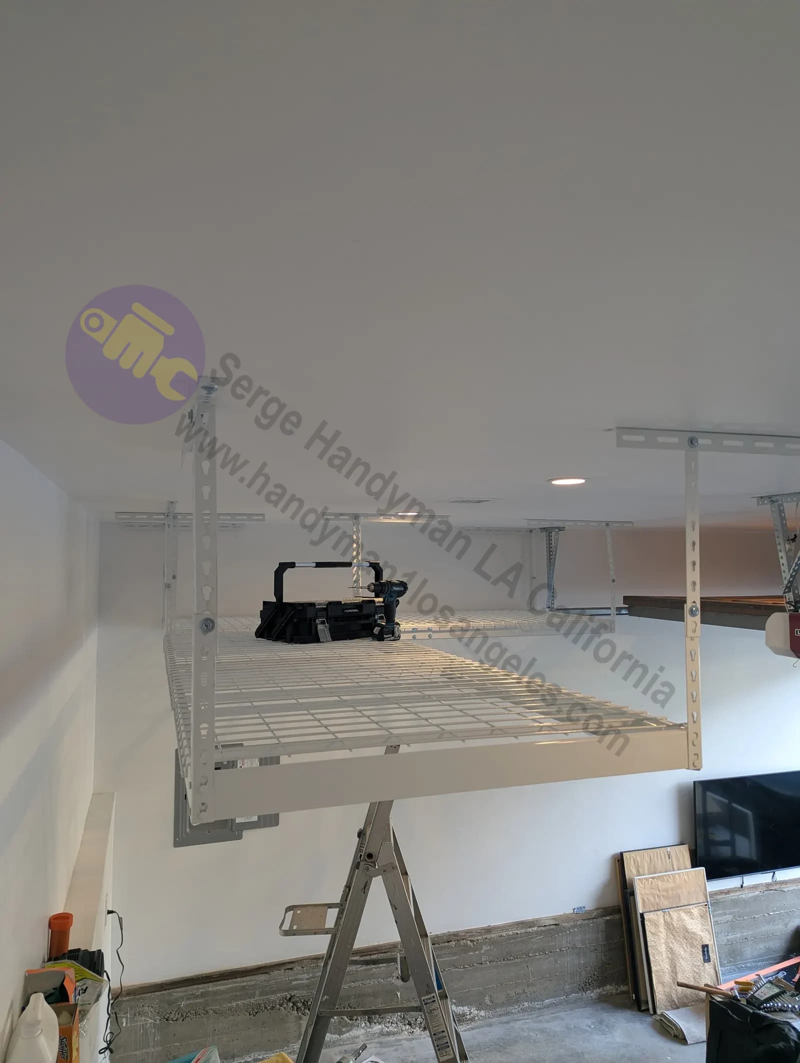 Professional installation of overhead garage storage racks mounted to ceiling joists in Los Angeles garage.